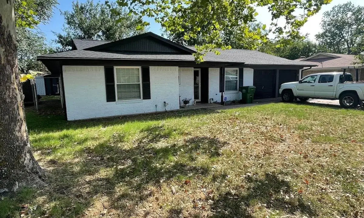 Professional roofing crew working on a residential roof in Ossining